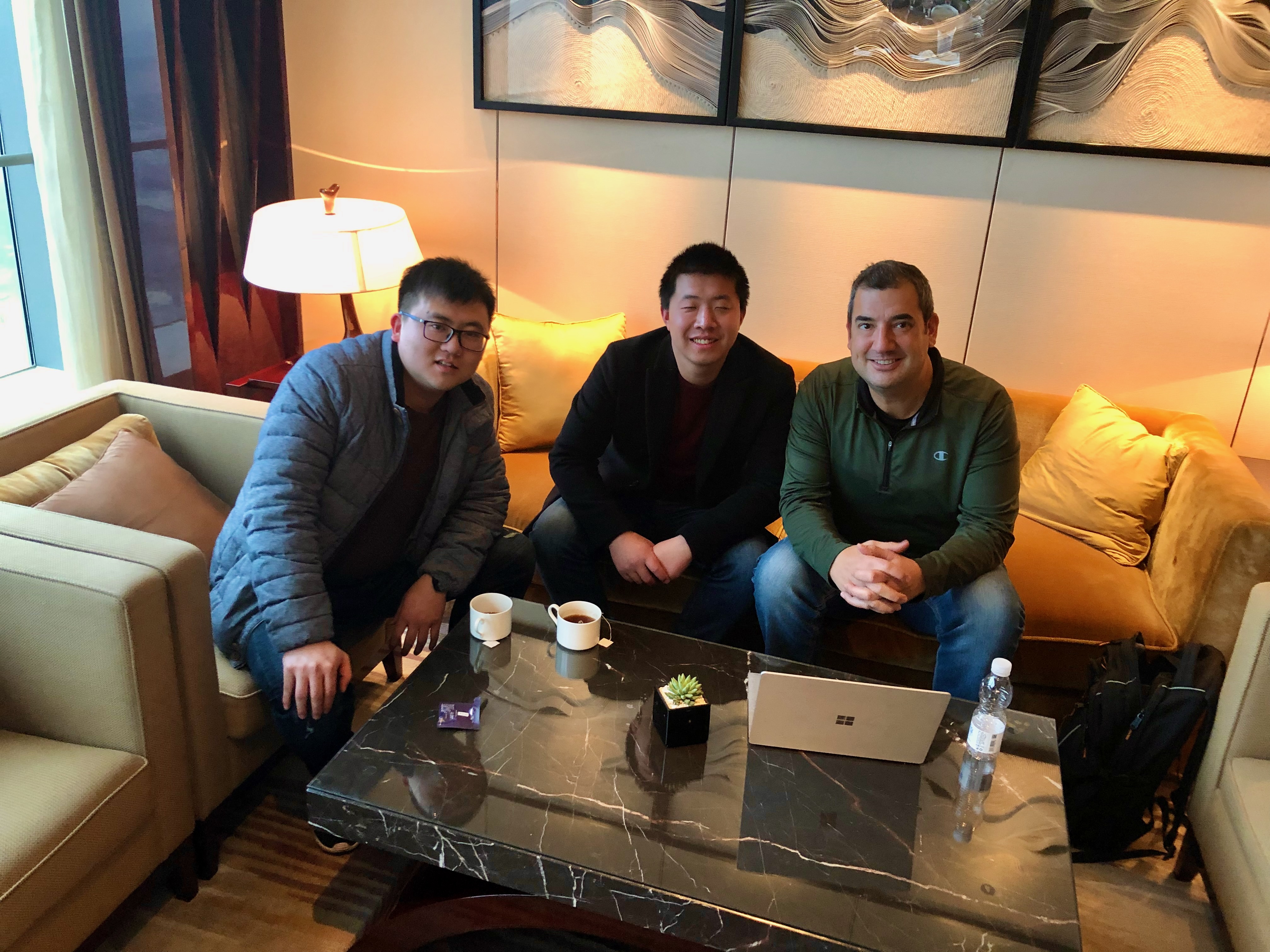 Patrick Maioho seated with two gentlemen